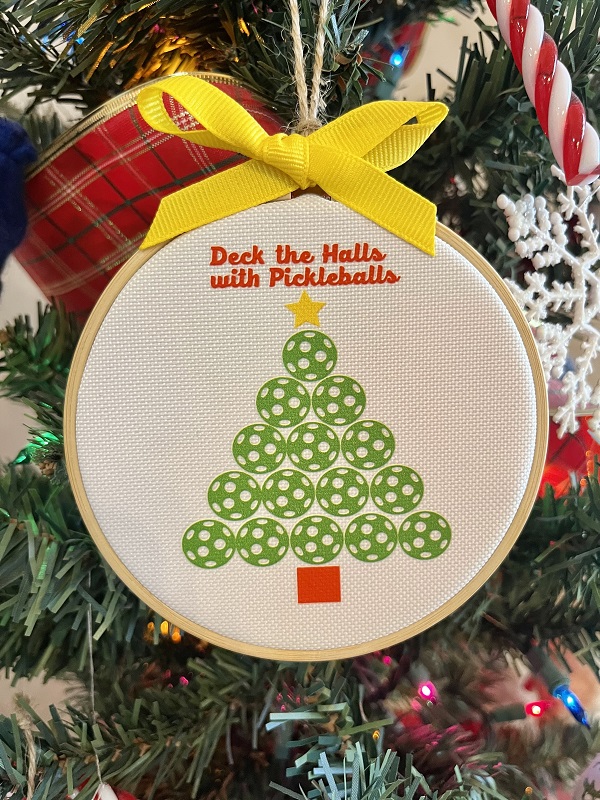 Deck the Halls with Pickleballs Ornament-4 inch wood hoop with design on a durable canvas finished with yellow grosgrain ribbon