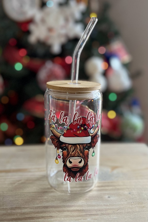 Falalala Highland Cow Beer Glass Can-adorned with Christmas lights is a uv dtf decal on a 16 oz iced coffee glass
