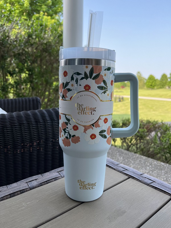 40 oz Flower Talk Tumbler-with a beautiful blue background 