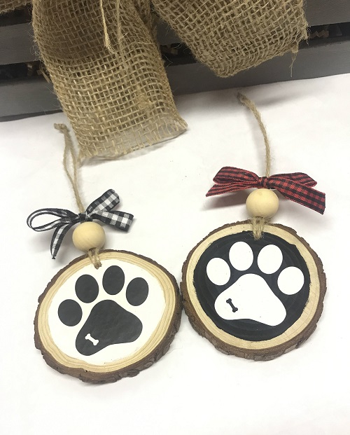 Dog Paw Ornament-on painted wood slice with bone shape cut out of the paw print