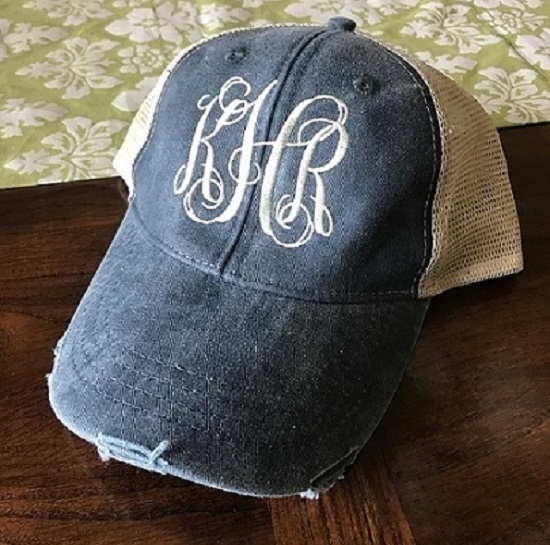 Distressed Trucker Hat-embroidered in interlocking font in eggshell thread color